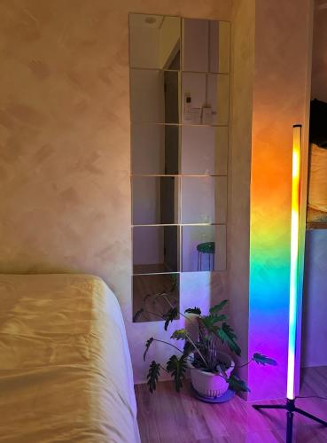 a room with a bed and a rainbow light at Casa Issabella Cozy & Stylish Studio in Sorsogon in Sipak