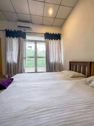 a bedroom with two beds and a window at Nature park hotel in Polonnaruwa