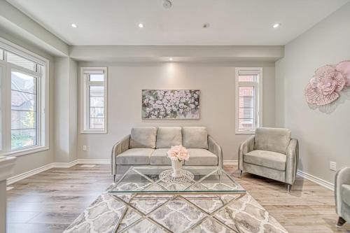 a living room with a couch and two chairs at Spacious 3BR Townhome Near Casino & Thermea Spa in Ajax