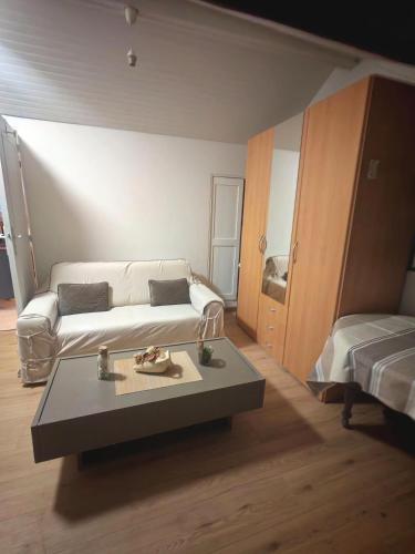 a living room with a couch and a coffee table at Nice studio in Paris suburbs in Épinay-sur-Seine