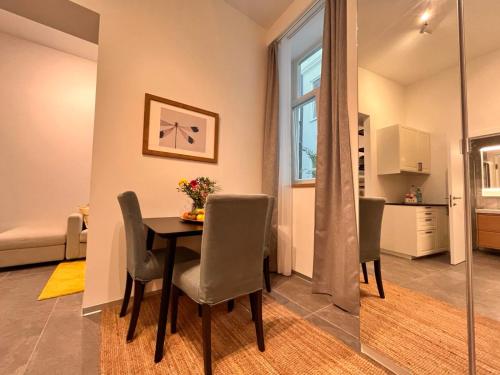a dining room with a table and chairs at Suite Nr 9 - J26 LUXURY APARTHOTEL, Jauniela 26 Old Riga - Top Location in Rīga