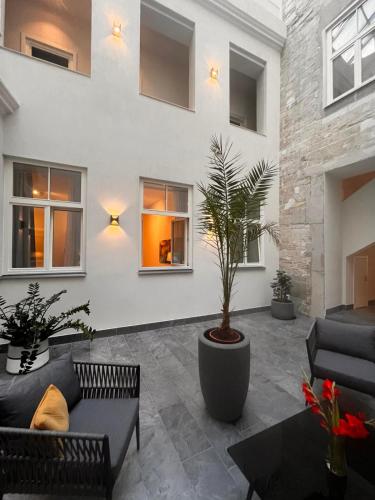 a living room with couches and a potted plant at Suite Nr 9 - J26 LUXURY APARTHOTEL, Jauniela 26 Old Riga - Top Location in Rīga