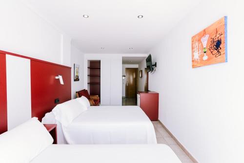 a hotel room with two beds and a hallway at Hospedium Hotel Continental in Mojácar