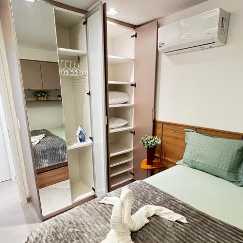 a small bedroom with a bed and a closet at Capri Residence Luxo 02 quartos by Premium Reservas in Porto De Galinhas