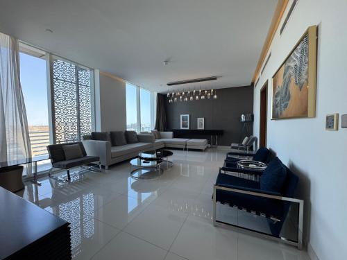 a living room with couches and tables in a room at 4Leisure Suites DAMAC Esclusiva Towers in Riyadh