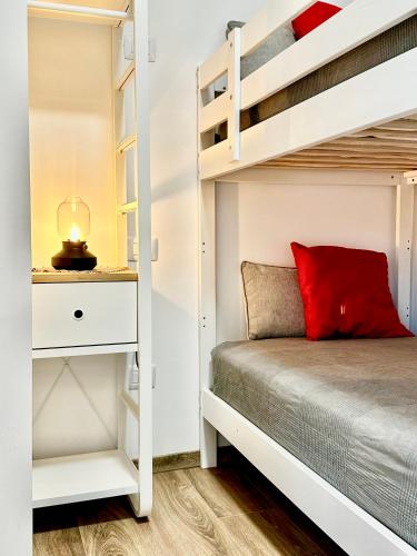 a bedroom with bunk beds and a red pillow at Le Dimore di Giove in Bevagna