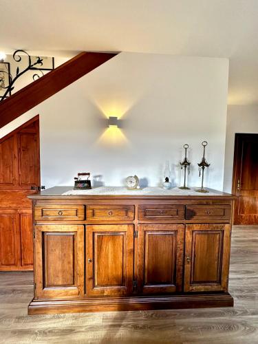 a kitchen with a large wooden island in a room at Le Dimore di Giove in Bevagna