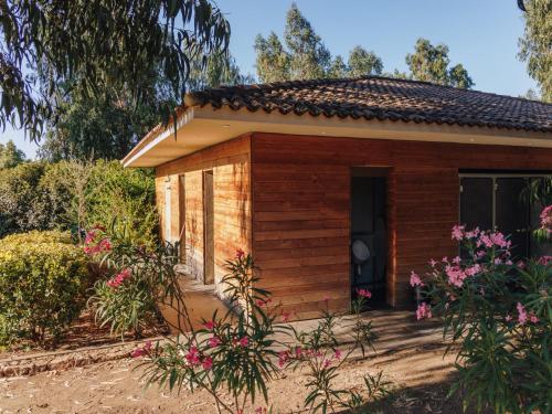a small wooden house with flowers in front of it at Vigna Maggiore in Olmeto
