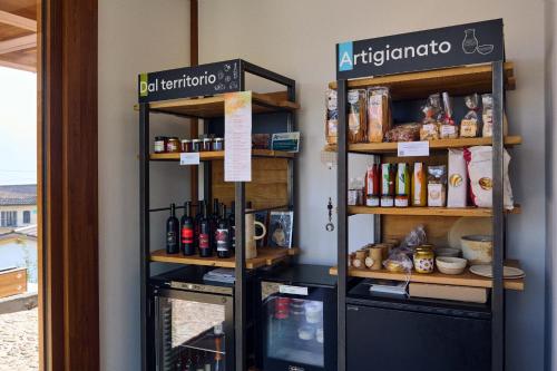 a room with two shelves with food items at Habitat Lago Maggiore in Gambarogno