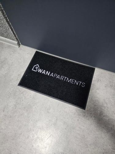 a sign on a table with the words swamiapatories at Apartamenty SWAN in Gliwice
