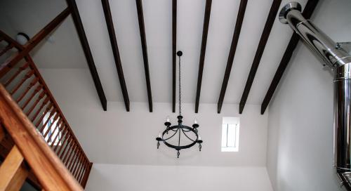 a chandelier hanging from a ceiling in a room at Deveron Valley Cottages in Marnoch