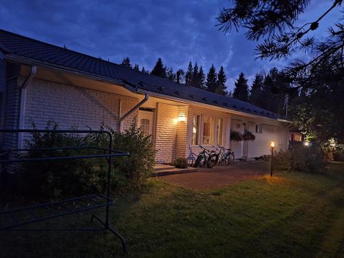 a house with bikes parked outside of it at night at Santa Claus House in Rovaniemi