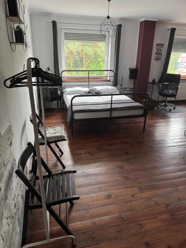 a bedroom with a bunk bed and a wooden floor at Studio na MIARĘ in Jarocin