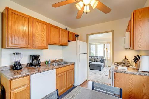 a kitchen with wooden cabinets and a white refrigerator at 30 Day Minimum - Entire House - Washer & Dryer and AC in Middleton