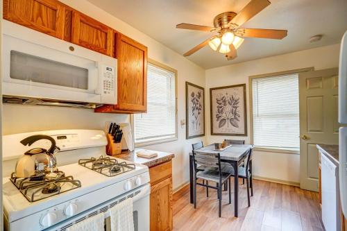 a kitchen with a stove top oven next to a table at 30 Day Minimum - Entire House - Washer & Dryer and AC in Middleton