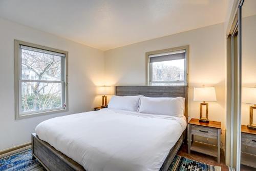 a bedroom with a large white bed with two windows at 30 Day Minimum - Entire House - Washer & Dryer and AC in Middleton