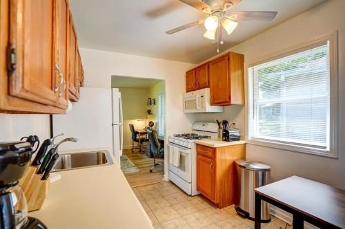 a kitchen with wooden cabinets and a white stove top oven at 30 Day Minimum - Entire House Deck close to Hosp in Middleton