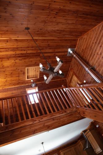 a chandelier hanging from the ceiling of a wooden building at Deveron Valley Cottages in Marnoch