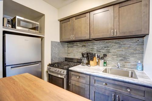 a kitchen with a sink and a stove and a refrigerator at Free Parking with Private Entrance - Close to Med Center in West Allis