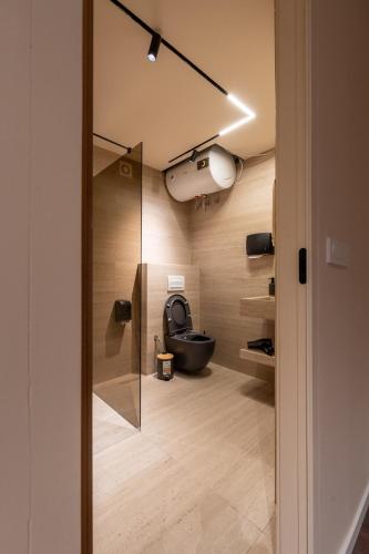 a bathroom with a toilet and a glass door at Aurelia Pristina in Pristina