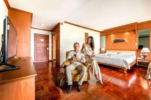 a man and a woman sitting in a hotel room at Studio Suite by Royal Ivory Nana in Bangkok