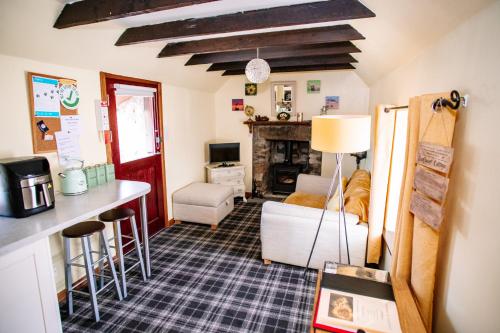 a living room with a couch and a table at Deveron Valley Cottages in Marnoch