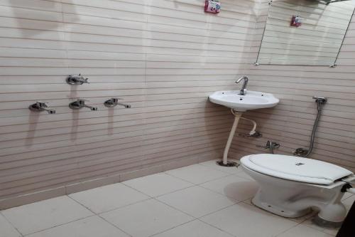 a bathroom with a toilet and a sink at Hotel O Ocean's 11 in Daurāla