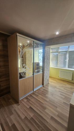 a room with a large glass door in a room at Хостел Твій Дім в Пирятині in Pyryatyn