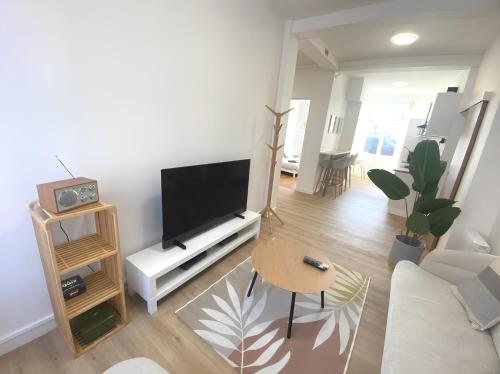 a living room with a large flat screen tv at Coeur de ville - Appartement 2 chambres in Amiens