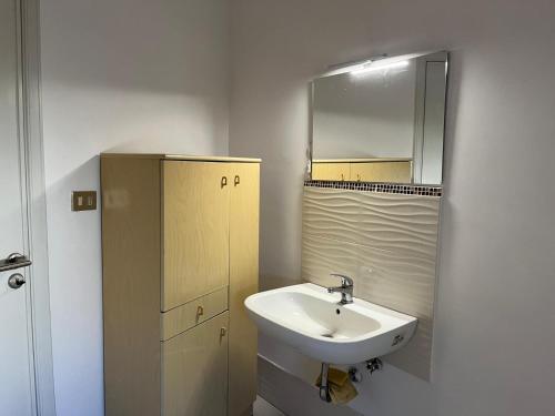 a bathroom with a sink and a mirror at Gattopardo's Taormina big house in Taormina