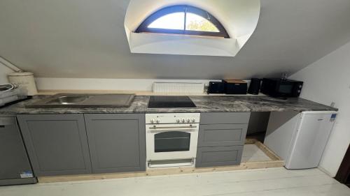 a kitchen with a stove and a sink and a window at Sancta Katharina in Rozvadov