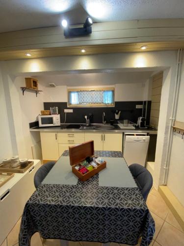 a small kitchen with a table in the middle of it at le lavandin in Lorgues