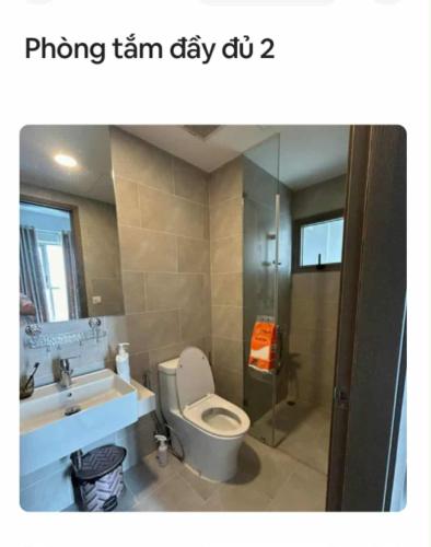 a bathroom with a toilet and a sink and a shower at Mickey home's in Ho Chi Minh City