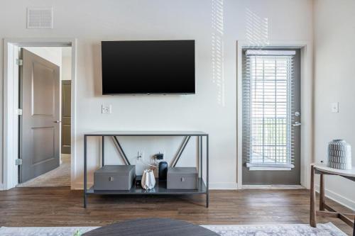 a living room with a tv on a wall at Landing at Marisol at Viera - Melbourne in Viera