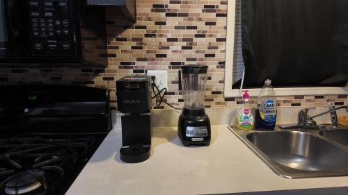 a blender sitting on a kitchen counter next to a sink at Faith short term rental in Romulus