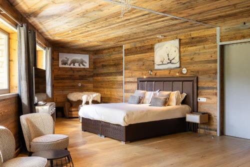 a bedroom with a bed in a room with wooden walls at Black Diamond - Tignes in Les Brévières