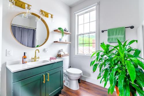 a bathroom with a green cabinet and a plant at Prime Location Top Rated Clean Parking Free! in Chillicothe