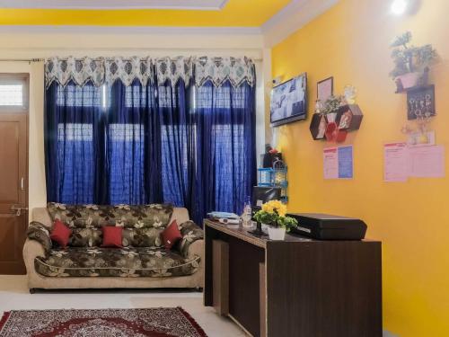 a living room with a couch and a window at Hotel O Prime Stayzz in Kaliānpur