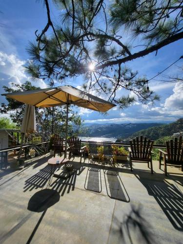 a patio with a table and chairs and an umbrella at Mây Nhà Tuii - Homestay in Da Lat in Ấp Ða Lợi