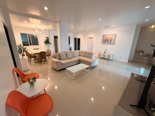 a living room with a couch and a table at Pool Villa Chiangmai airport ABA 4 Bedroom in Chiang Mai