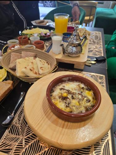 a table with a bowl of food on a table at Centre ville Plage, 1 seule chambre bedroom pour famille ou personnes sérieuses in El Jadida