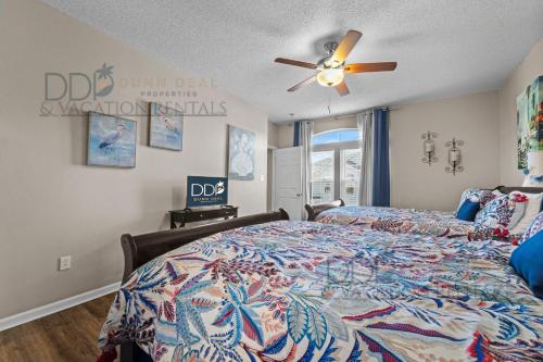 Un dormitorio con una cama y un ventilador de techo. en Legacy Villa 1503, en Gulfport