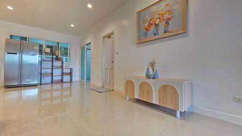 a large living room with a refrigerator and a table at Pool Villa Chiangmai airport ABA 4 Bedroom in Chiang Mai
