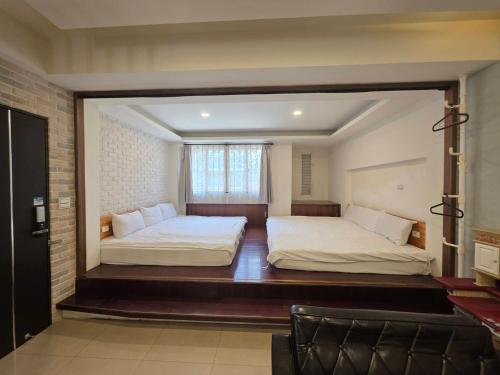 two beds in a room with a mirror between them at Q House in Puli