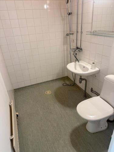 a bathroom with a toilet and a sink at Apartment 1-3 in a quiet location check-in 247 in Kemi