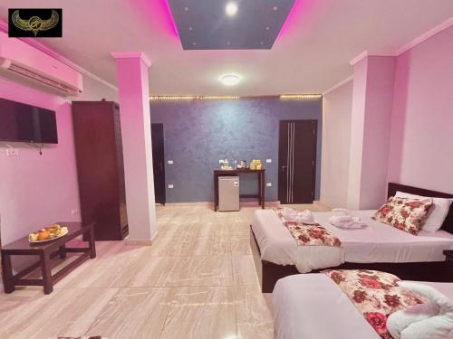 a large room with two beds and a table at Comfort Inn Pyramids Hotel in Cairo
