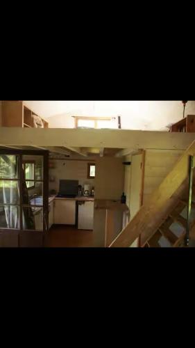 a view of a kitchen and a living room at Cabane en bois in Saint-Antonin-Noble-Val