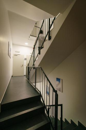 a staircase in an office building with a stair case at Hotel Waibstadter Hof in Waibstadt