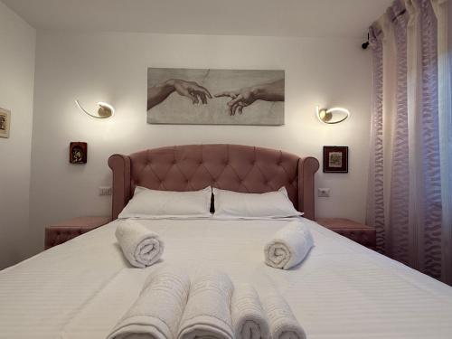 a bedroom with a large bed with towels on it at Central Bliss 3 rooms in Iaşi