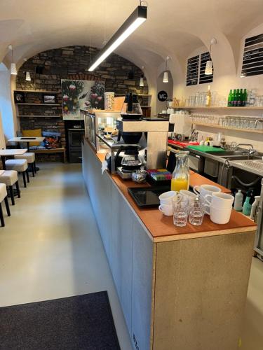 a large kitchen with a counter with dishes on it at Karlštejn 34 in Karlštejn